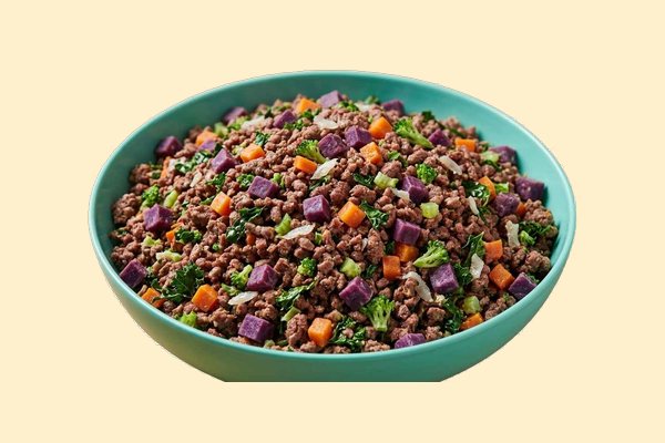 A bowl of cooked ground beef with diced sweet potato, broccoli, kale and sardines