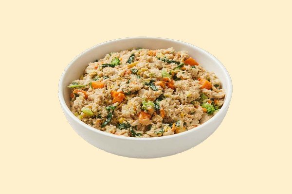 A bowl of cooked chicken with butternut squash, broccoli, spinach and brown rice