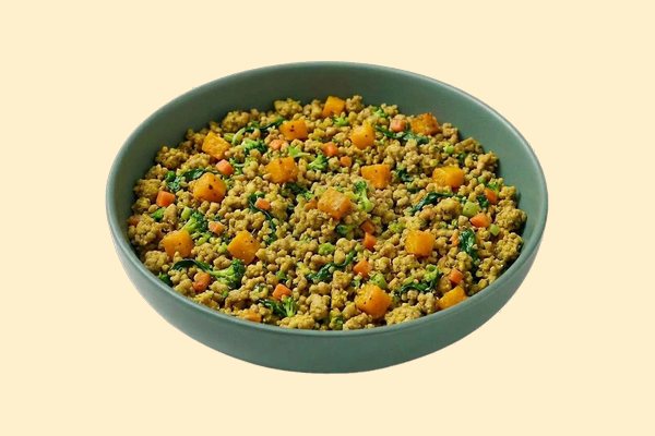 A bowl of cooked ground turkey with butternut squash, broccoli, spinach and turmeric