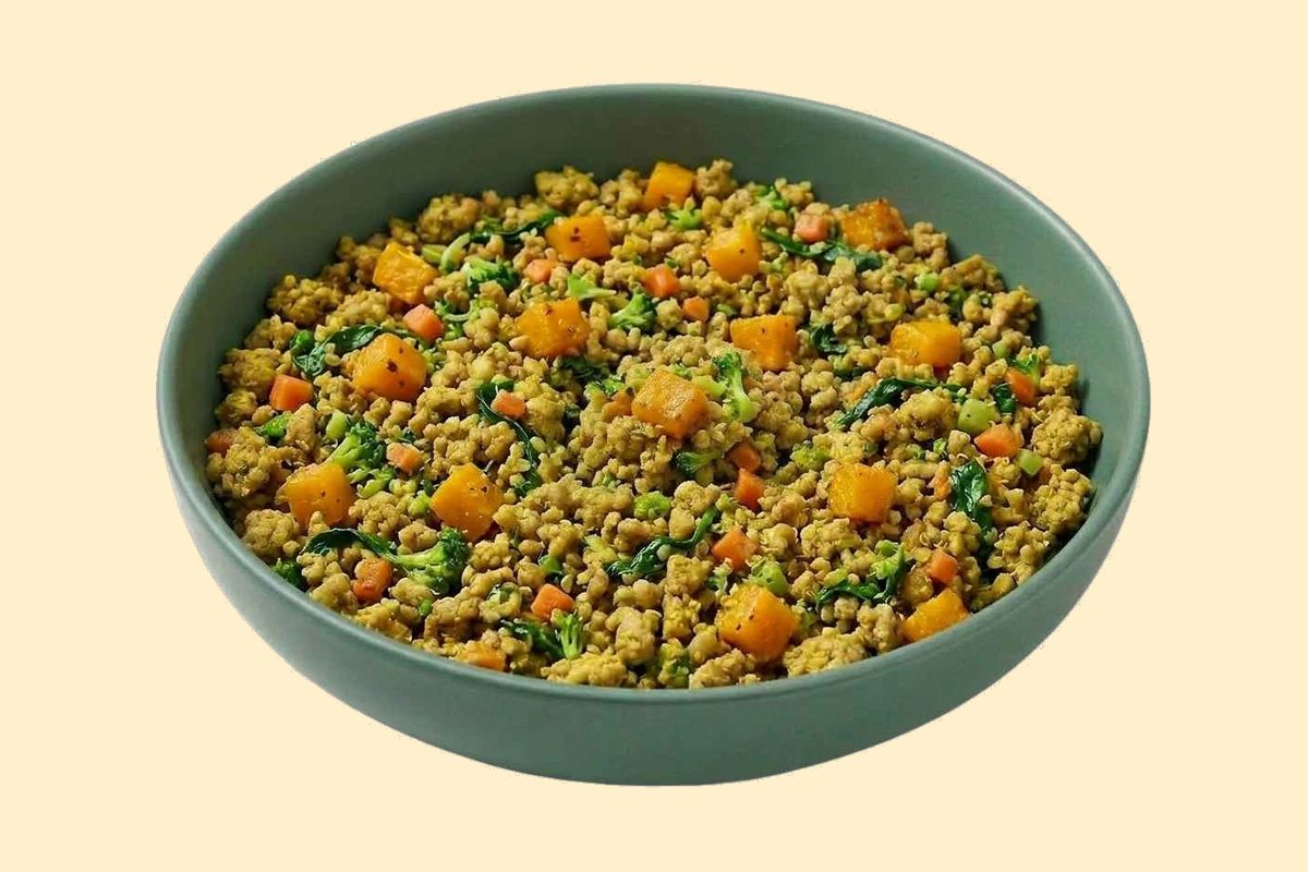 A bowl of cooked ground turkey with butternut squash, broccoli, spinach and turmeric